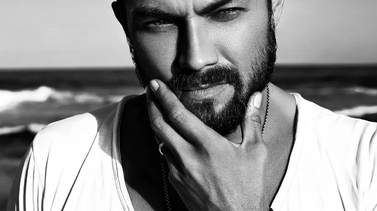 portrait handsome fashion man model wearing white clothes posing blue sea